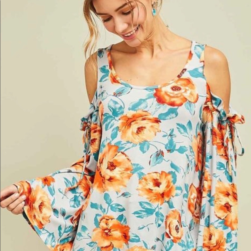 Lightweight cold shoulder orange print top.